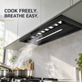 Snifz Magic 12 hidden chimney range hood installed under cabinet in a modern kitchen